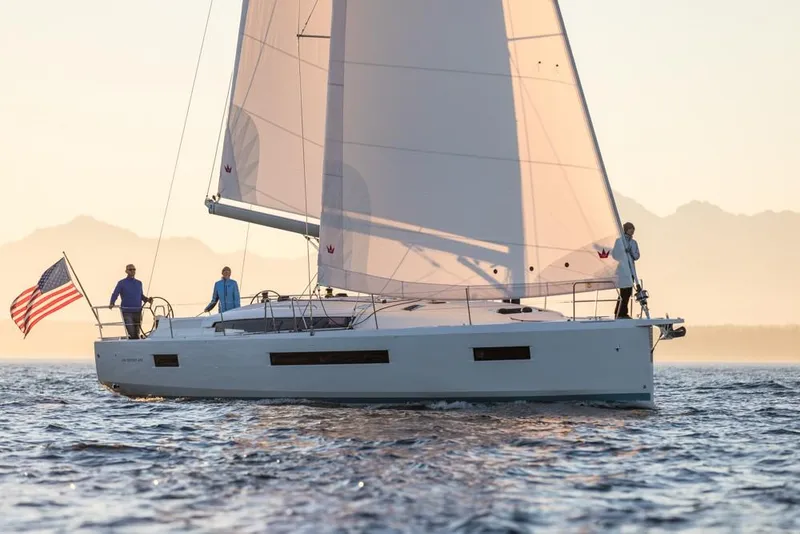 Slide: The Image of 2024 Jeanneau Sun Odyssey 490 sailing on calm waters at sunset. - 47