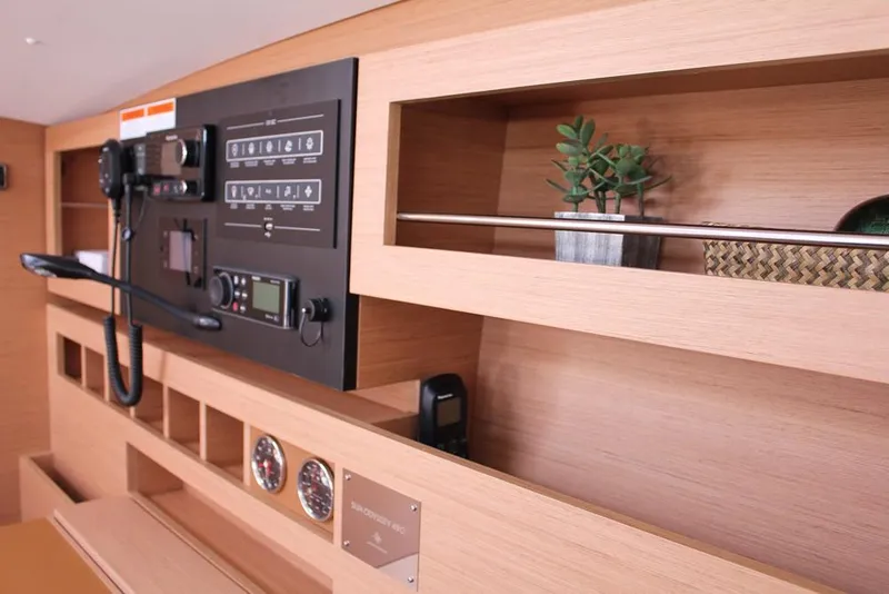 Slide: The Image of 2024 Jeanneau Sun Odyssey 490 interior with control panel and shelving. - 8