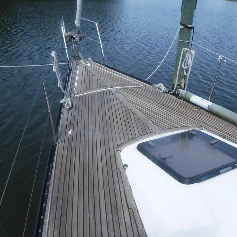 Slide: The Image of X-Yachts 2002 Model X-412 Mk III sailboat deck, wooden finish, docked on calm water. - 18
