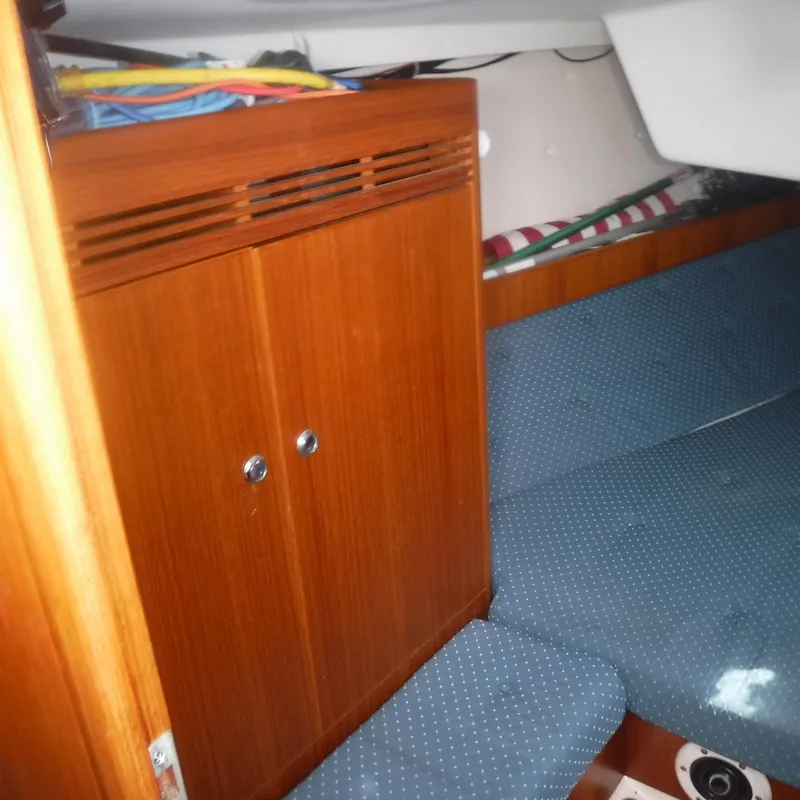 Slide: The Image of Interior of 2001 X-Yachts X-412 Mk III with wooden cabinet and blue seating. - 34