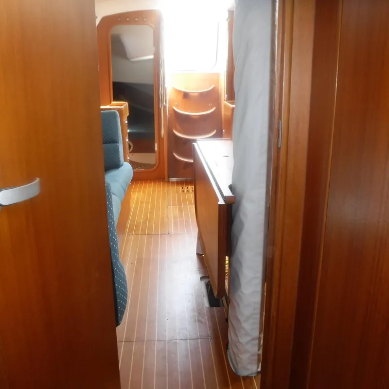 Slide: The Image of Interior of 2001 X-Yachts X-412 Mk III, featuring wooden flooring and cozy cabin space. - 37