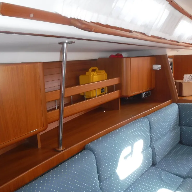 Slide: The Image of Interior of 2001 X-Yachts X-412 Mk III, featuring wooden cabinetry and blue upholstered seating. - 40