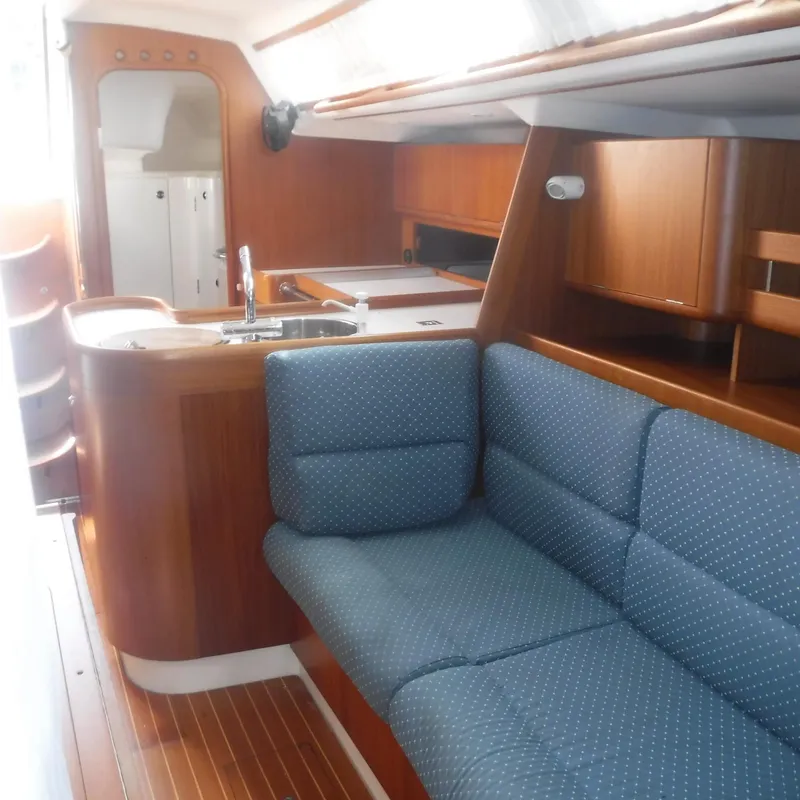 Slide: The Image of Interior of 2001 X-Yachts X-412 Mk III, featuring wooden cabinetry and blue upholstered seating. - 41