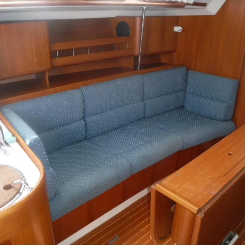 Slide: The Image of Interior of 2001 X-Yachts X-412 Mk III with blue cushioned seating and wooden finish. - 42