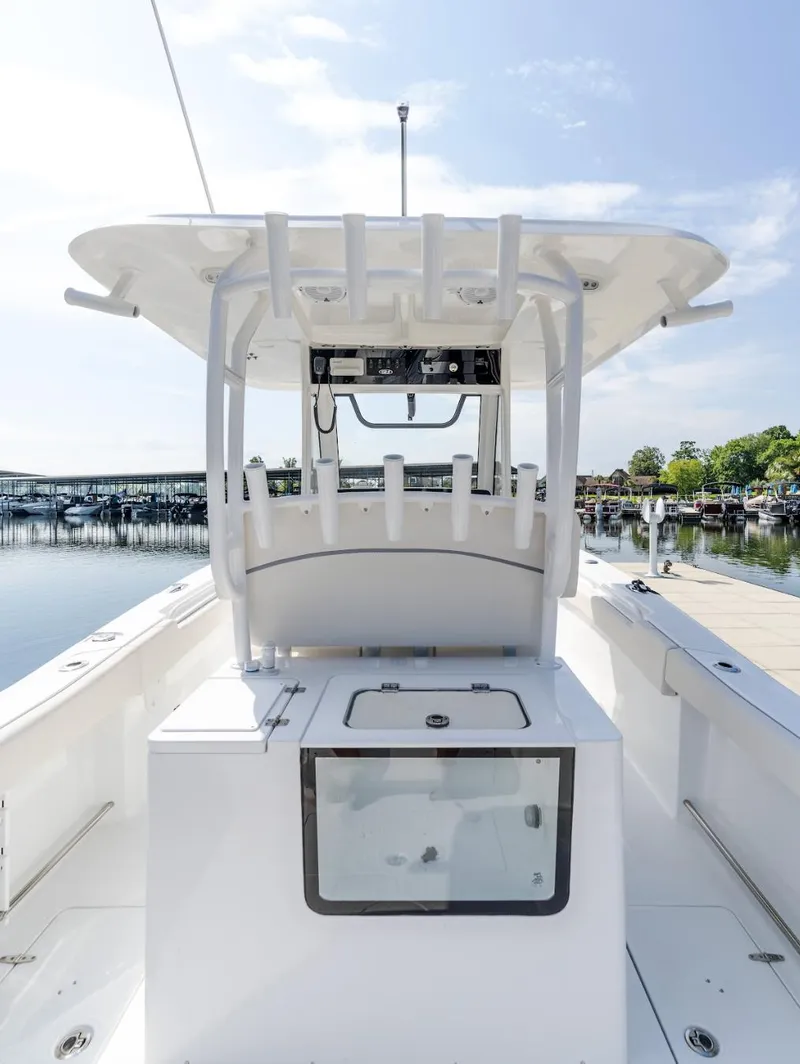 Slide: The Image of 2025 Sea Hunt Gamefish 30 boat with coffin box, docked at marina. - 17