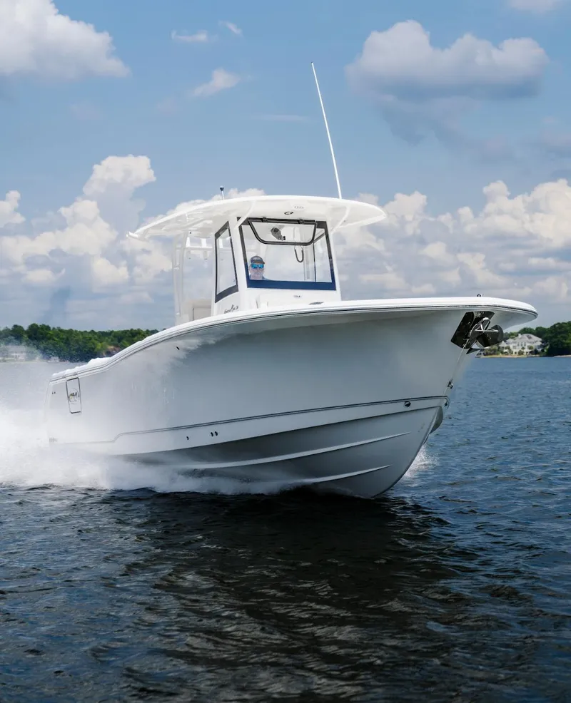 Slide: The Image of 2025 Sea Hunt Gamefish 30 with Coffin Box cruising on water under blue sky. - 19