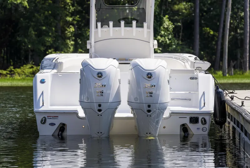 Slide: The Image of 2025 Sea Hunt Gamefish 30 with twin engines, docked on calm water. - 2