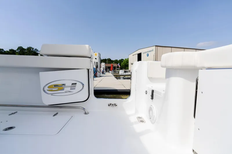 Slide: The Image of 2025 Sea Hunt Gamefish 30 boat deck with coffin box, docked under clear sky. - 20