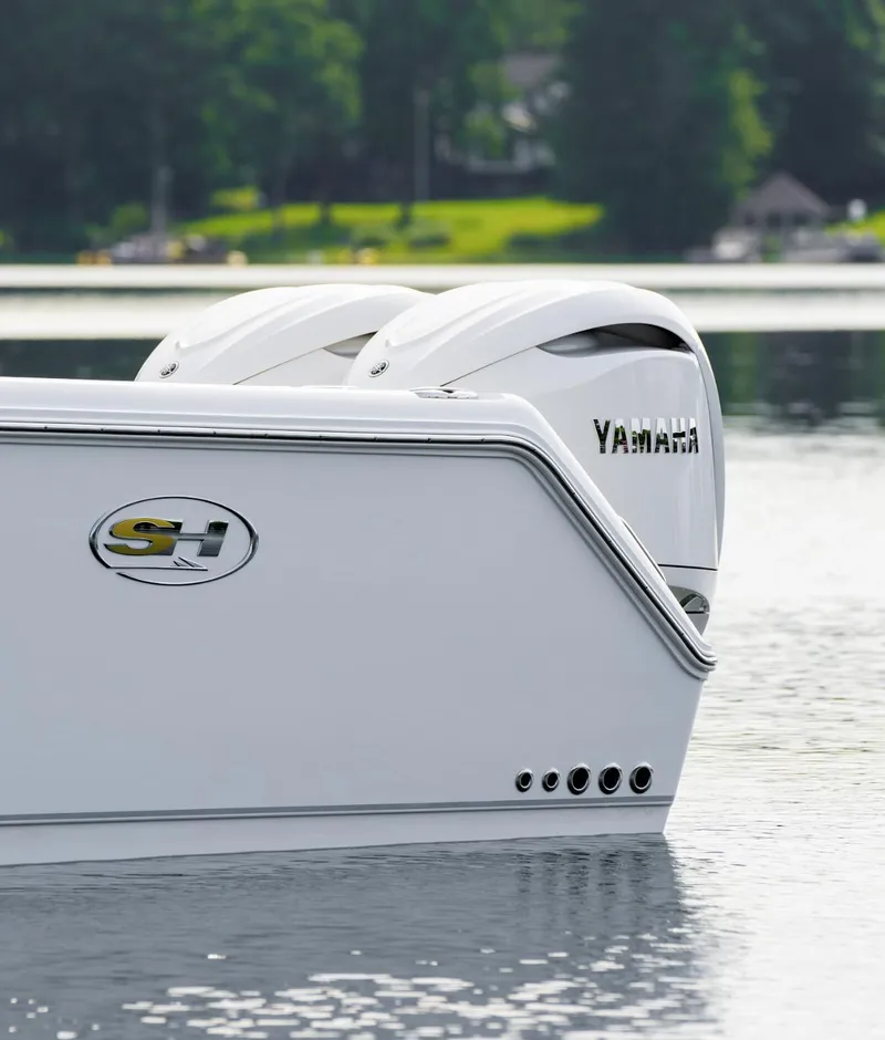 Slide: The Image of 2025 Sea Hunt Gamefish 30 with Coffin Box, featuring dual Yamaha engines on a serene lake. - 21
