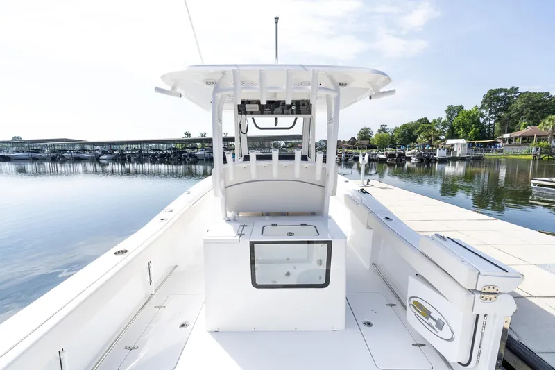 Slide: The Image of 2025 Sea Hunt Gamefish 30 with Coffin Box, docked on a serene lake. - 22