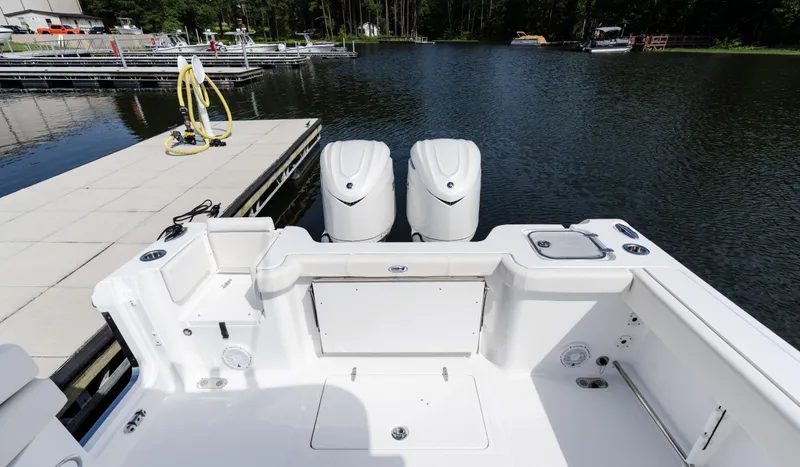 Slide: The Image of 2025 Sea Hunt Gamefish 30 with Coffin Box, docked by a serene lake. - 23