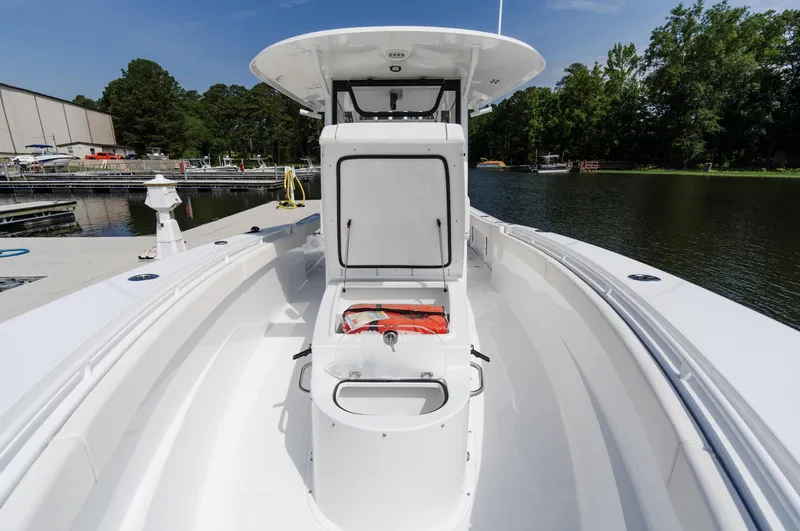 Slide: The Image of 2025 Sea Hunt Gamefish 30 with Coffin Box, docked by a serene lake. - 3