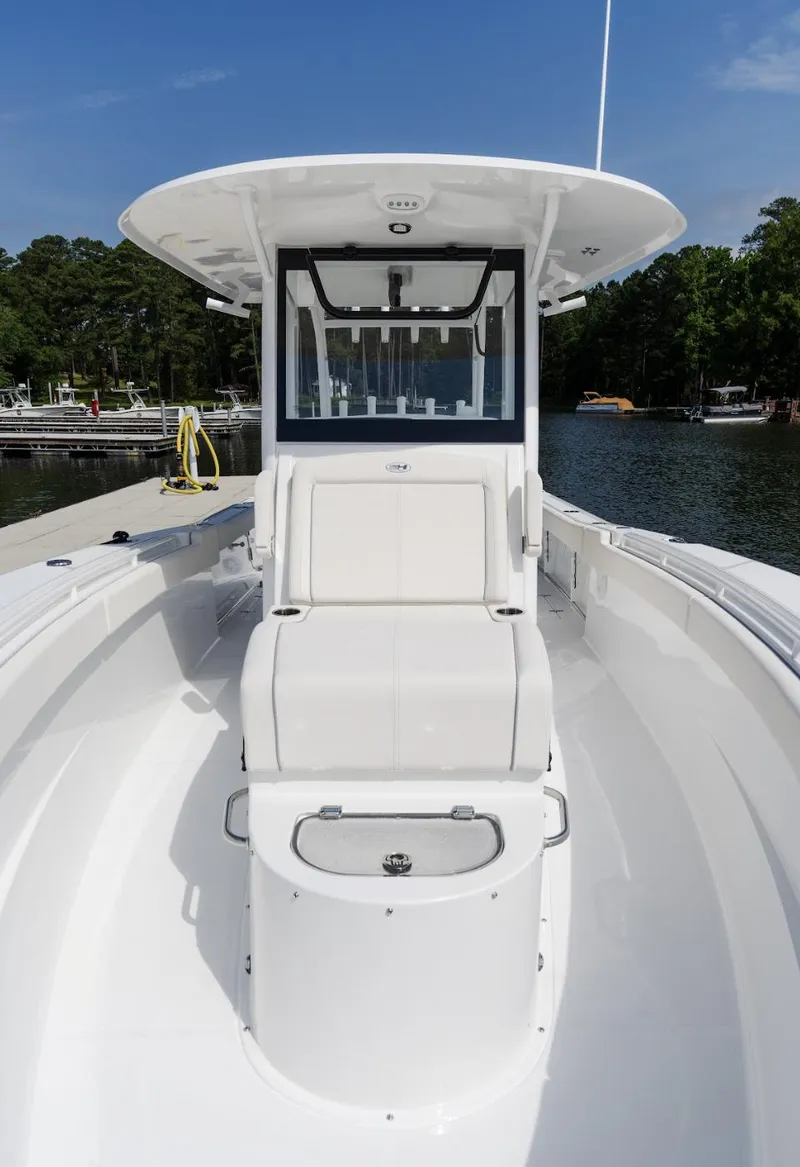 Slide: The Image of 2025 Sea Hunt Gamefish 30 with Coffin Box, sleek design, docked by a serene lake. - 4