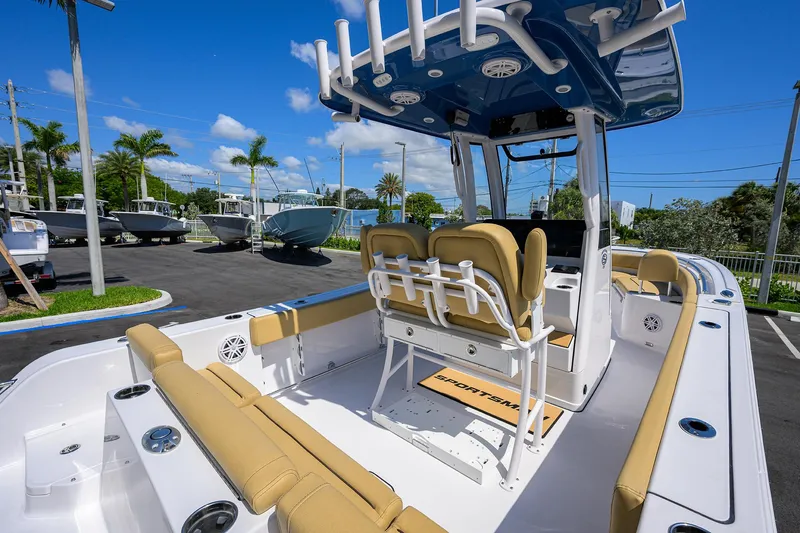 Slide: The Image of 2025 Sportsman Heritage 231 Center Console boat with tan seating and blue canopy. - 11