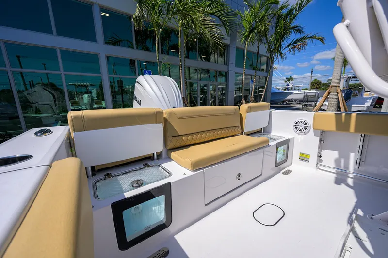Slide: The Image of 2025 Sportsman Heritage 231 Center Console boat interior with tan seating and modern amenities. - 15