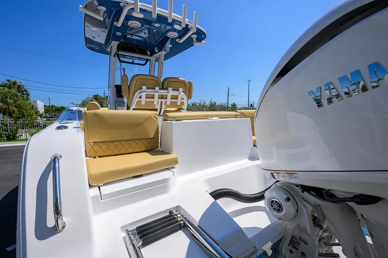 Slide: The Image of 2025 Sportsman Heritage 231 Center Console boat with Yamaha engine, featuring tan seating and sleek design. - 16