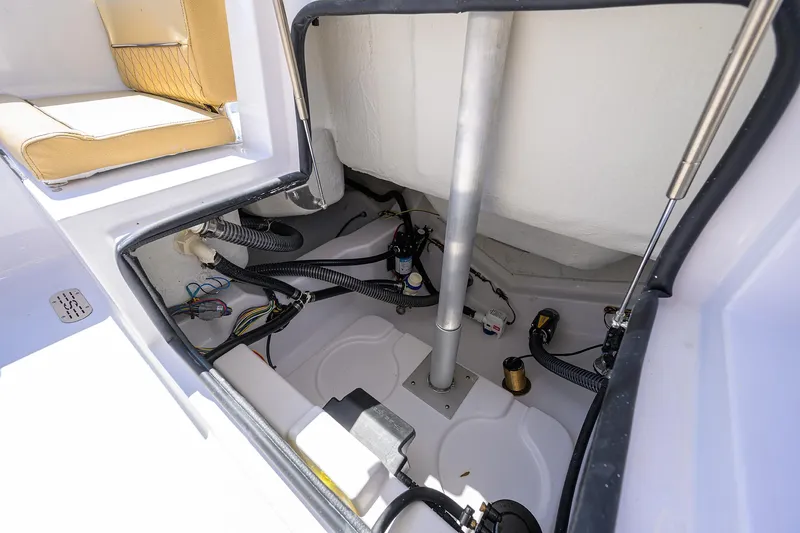 Slide: The Image of 2025 Sportsman Heritage 231 Center Console boat interior wiring and storage compartment. - 18