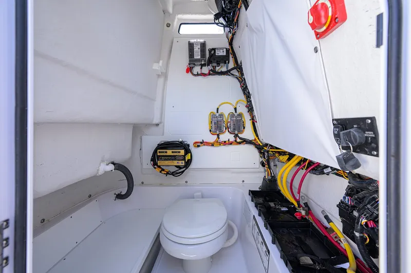 Slide: The Image of 2025 Sportsman Heritage 231 Center Console interior with marine toilet and electrical components. - 20