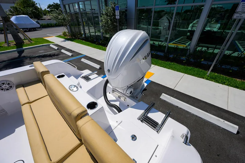 Slide: The Image of 2025 Sportsman Heritage 231 Center Console boat with Yamaha outboard engine, parked outdoors. - 22