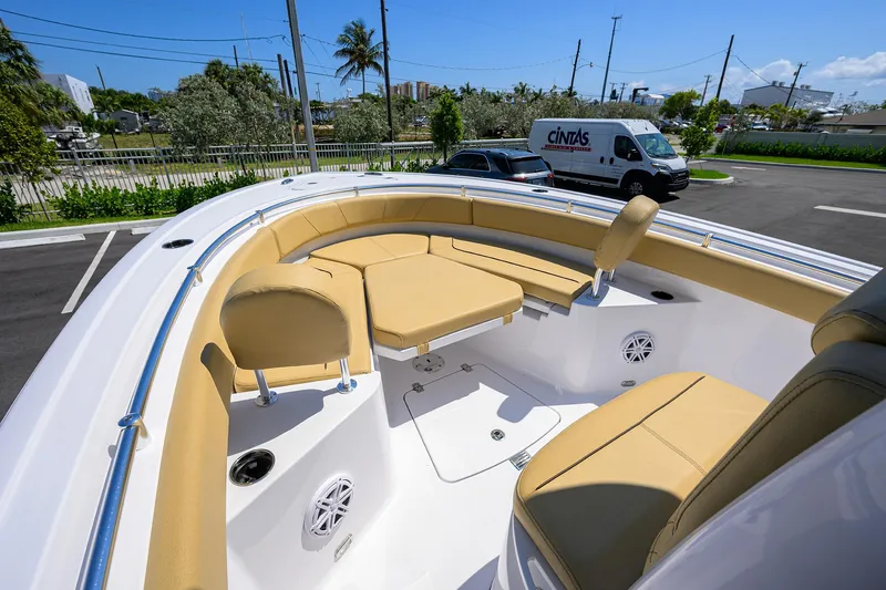 Slide: The Image of 2025 Sportsman Heritage 231 Center Console boat with tan seating in a parking lot. - 4