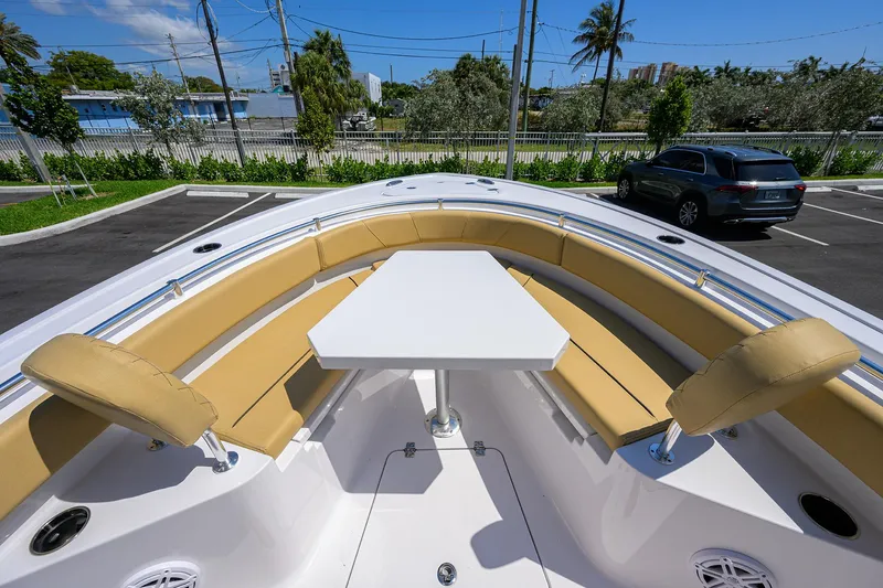 Slide: The Image of 2025 Sportsman Heritage 231 Center Console boat with tan seating and white table. - 5
