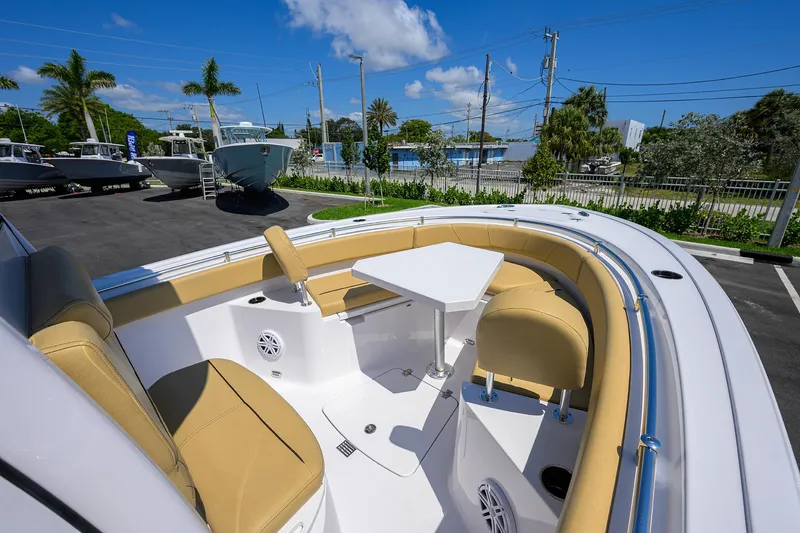 Slide: The Image of 2025 Sportsman Heritage 231 Center Console boat with tan seating and table. - 6