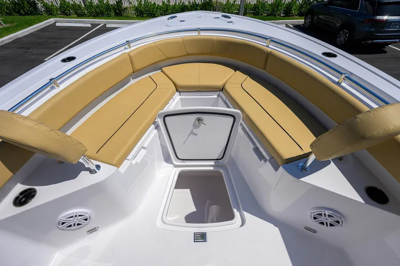 Slide: The Image of 2025 Sportsman Heritage 231 Center Console boat with tan seating and storage compartments. - 7