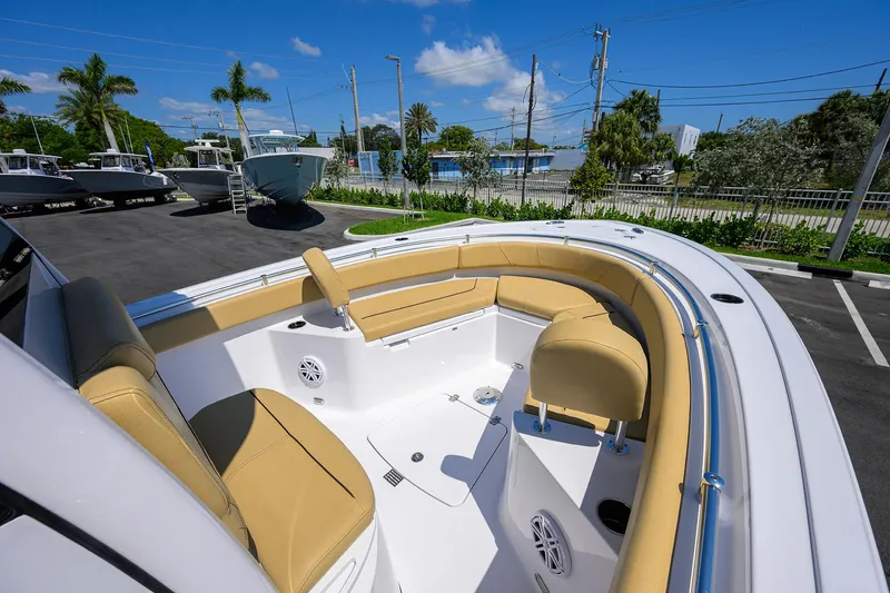 Slide: The Image of 2025 Sportsman Heritage 231 Center Console boat with tan seating, parked outdoors. - 9