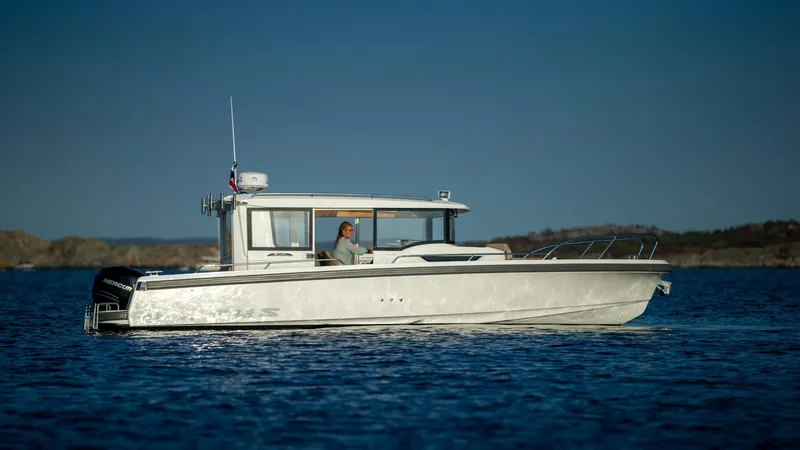 Slide: The Image of 2024 Nimbus C9 boat cruising on calm blue water. - 2