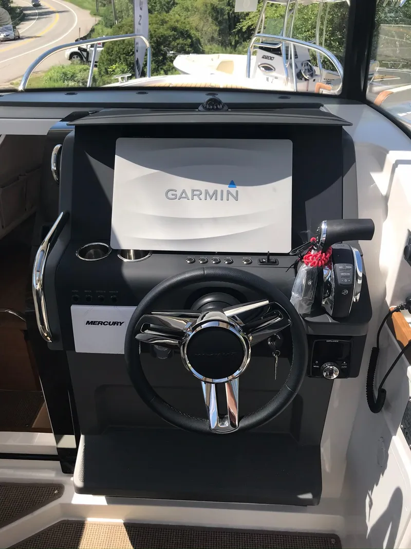 Slide: The Image of 2024 Nimbus C9 boat dashboard with Garmin navigation system and Mercury controls. - 20