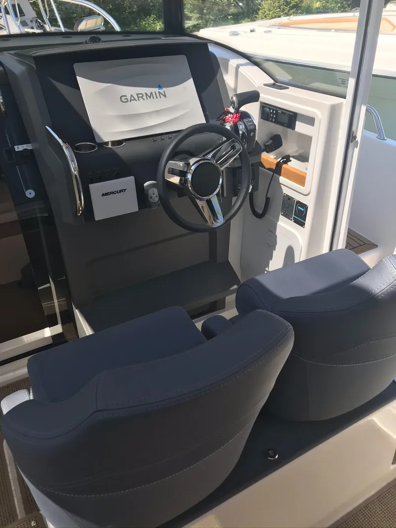 Slide: The Image of 2024 Nimbus C9 boat cockpit with Garmin navigation system and dual seats. - 22