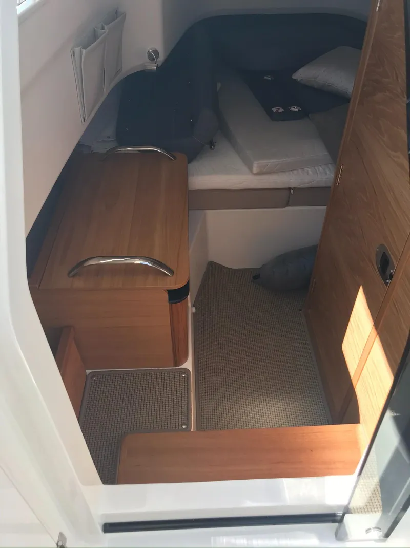 Slide: The Image of 2024 Nimbus C9 cabin interior with wooden finishes and cozy seating. - 23