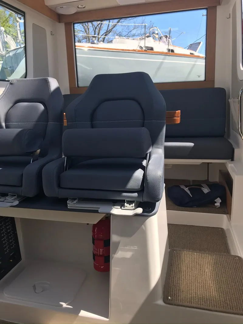 Slide: The Image of 2024 Nimbus C9 boat interior with plush seating and modern design. - 27