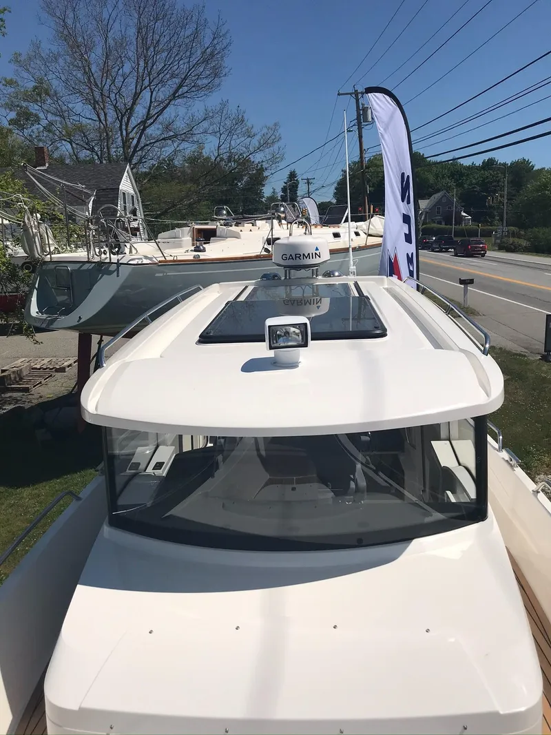 Slide: The Image of 2024 Nimbus C9 boat with Garmin equipment, displayed outdoors near a road. - 28