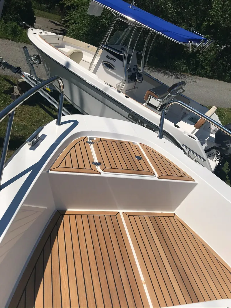 Slide: The Image of 2024 Nimbus C9 boat with teak deck and blue canopy. - 29