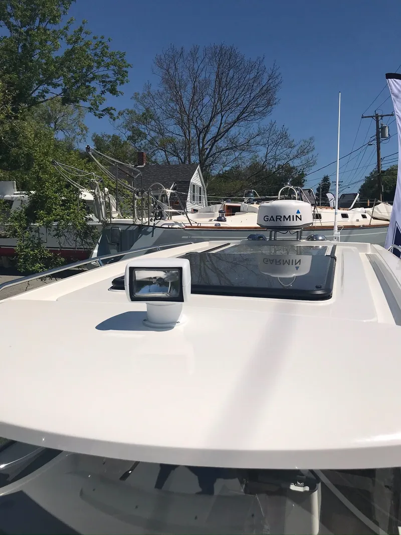 Slide: The Image of 2024 Nimbus C9 boat with Garmin equipment on deck, under clear blue sky. - 30