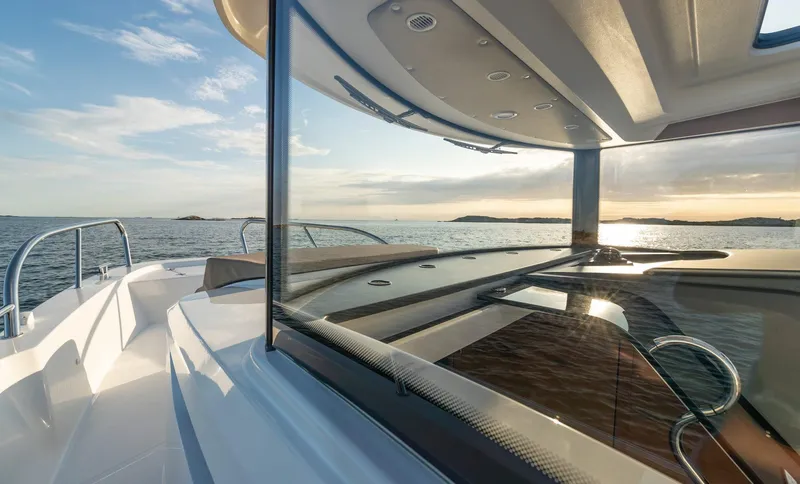 Slide: The Image of 2024 Nimbus C9 boat with sleek design on open water at sunset. - 8