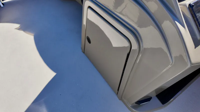 Slide: The Image of 2025 Sylvan Mirage 820 LZ boat storage compartment, sleek design, gray finish. - 10