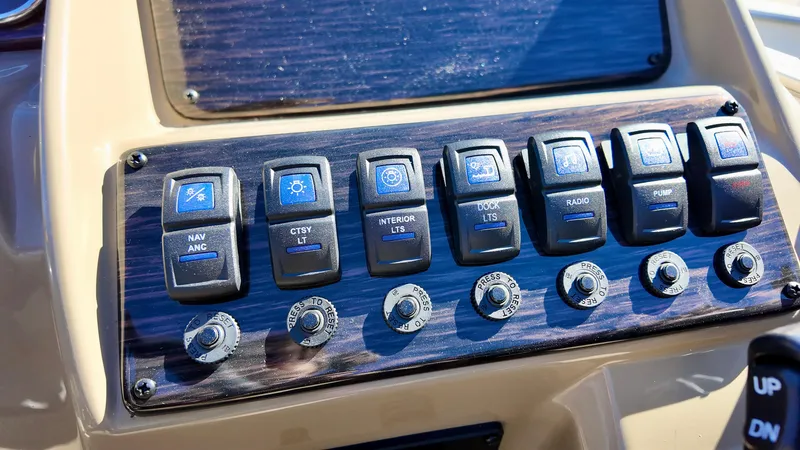 Slide: The Image of Control panel of 2025 Sylvan Mirage 820 LZ boat with labeled switches and knobs. - 12