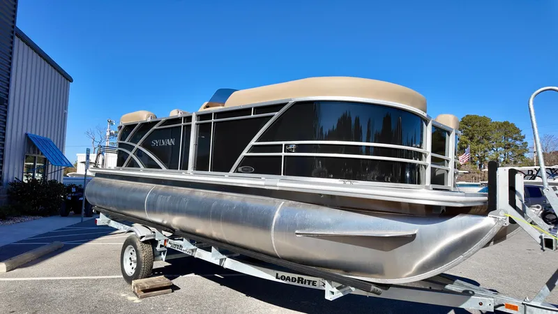 Slide: The Image of 2025 Sylvan Mirage 820 LZ pontoon boat on trailer, parked outdoors. - 8
