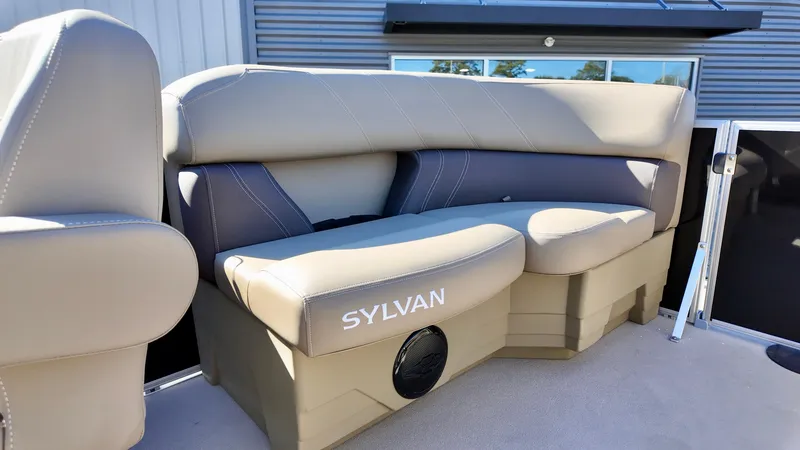 Slide: The Image of 2025 Sylvan Mirage 820 LZ boat seating with beige upholstery and speaker. - 9