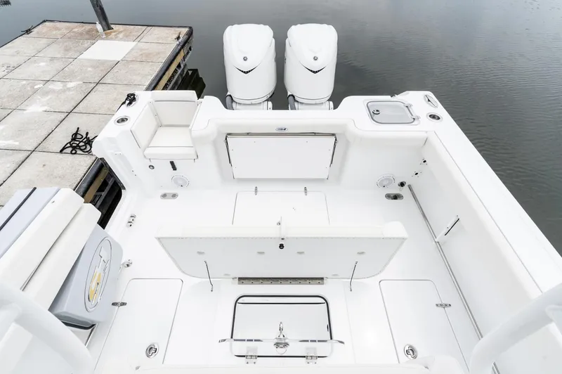 Slide: The Image of 2025 Sea Hunt Gamefish 30 boat with forward seating, docked by the water. - 10