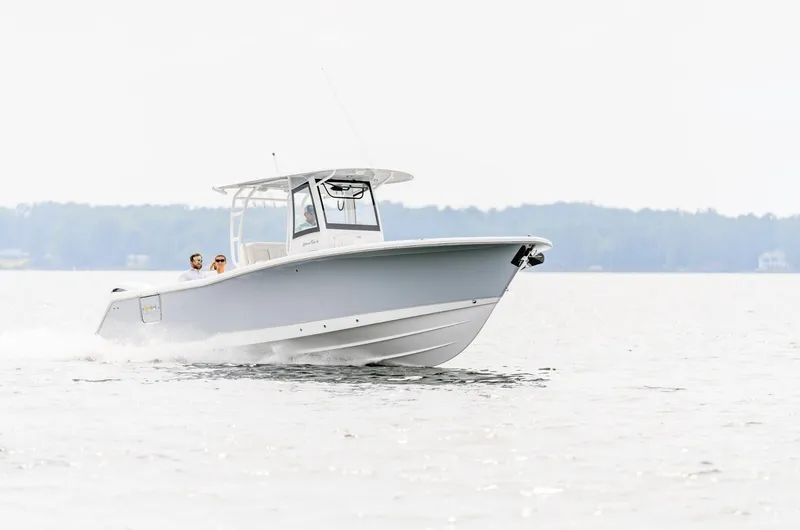 Slide: The Image of 2025 Sea Hunt Gamefish 30 Forward Seating boat cruising on open water. - 12
