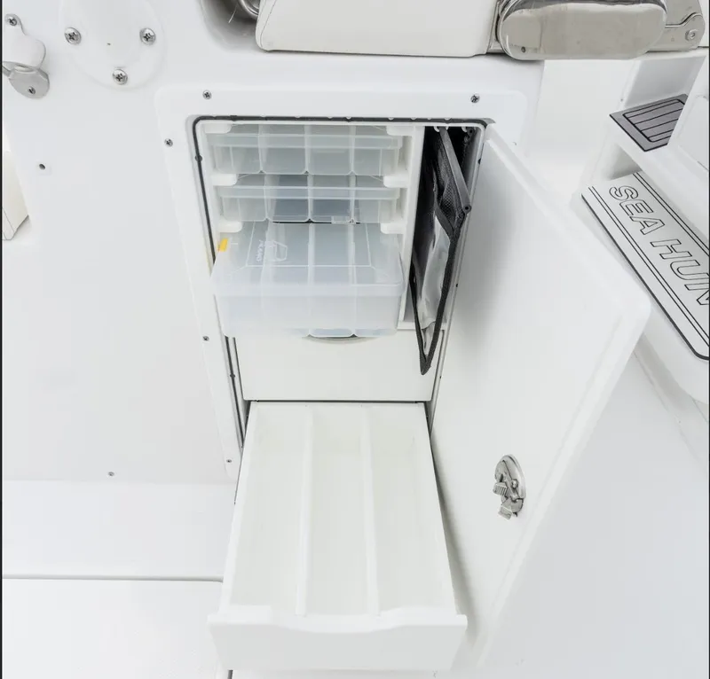 Slide: The Image of 2025 Sea Hunt Gamefish 30 storage compartment with open tackle box and drawer. - 17