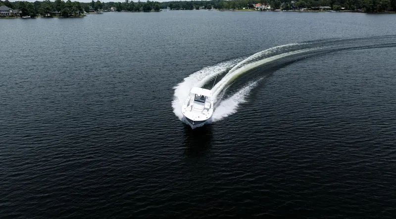 Slide: The Image of 2025 Sea Hunt Gamefish 30 cruising on a lake, creating a dynamic water trail. - 21