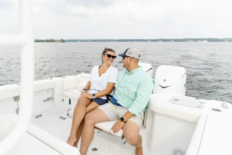 Slide: The Image of Couple relaxing on 2025 Sea Hunt Gamefish 30 boat, enjoying a scenic water view. - 23