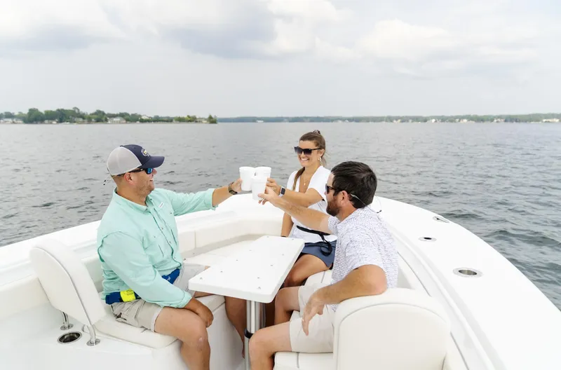 Slide: The Image of People enjoying drinks on a 2025 Sea Hunt Gamefish 30 boat. - 32