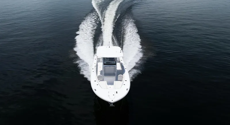 Slide: The Image of 2025 Sea Hunt Gamefish 30 boat cruising on open water, aerial view. - 6