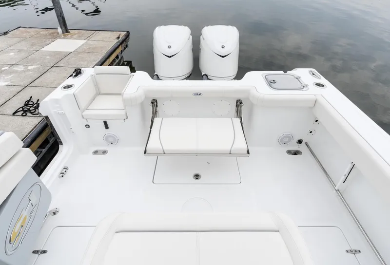 Slide: The Image of 2025 Sea Hunt Gamefish 30 boat with forward seating and dual engines at dock. - 9