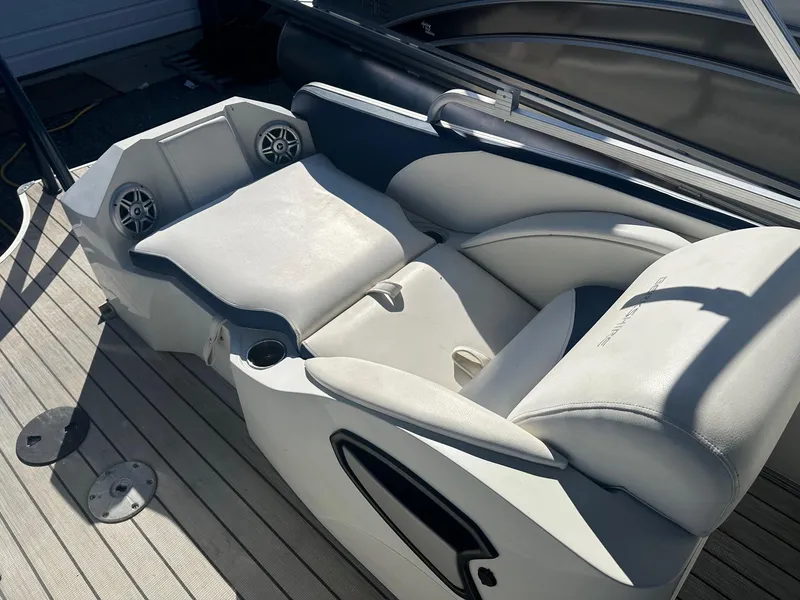 Slide: The Image of 2017 Berkshire 23SLX STS Entertainment boat seating with speakers and cup holders. - 10